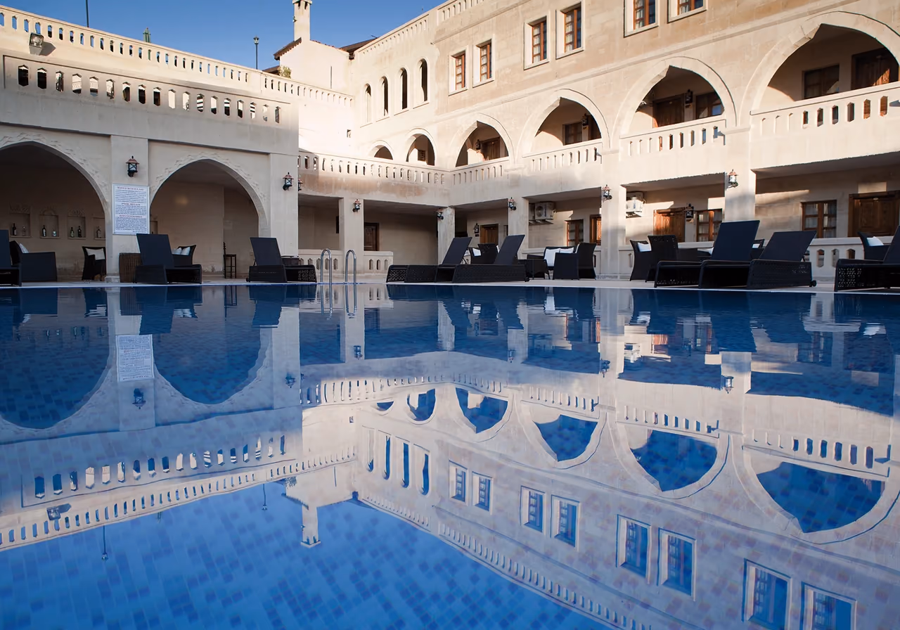The hotel’s stone arches reflected in the outdoor pool